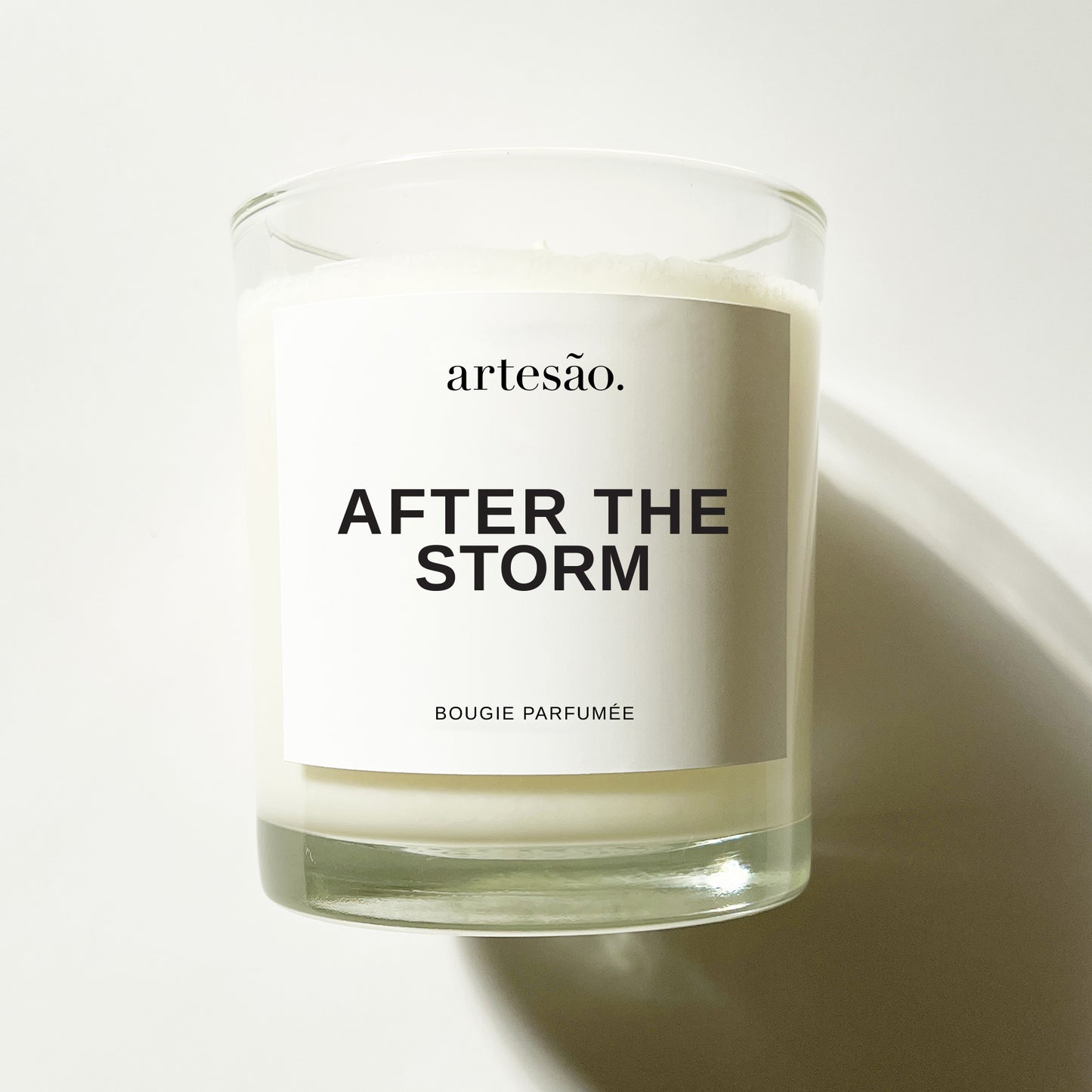 After The Storm Candle - clear glass vessel with white and black label and artesao logo